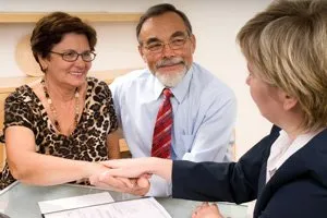 Photo of oral surgery office staff working with patients on their financial options